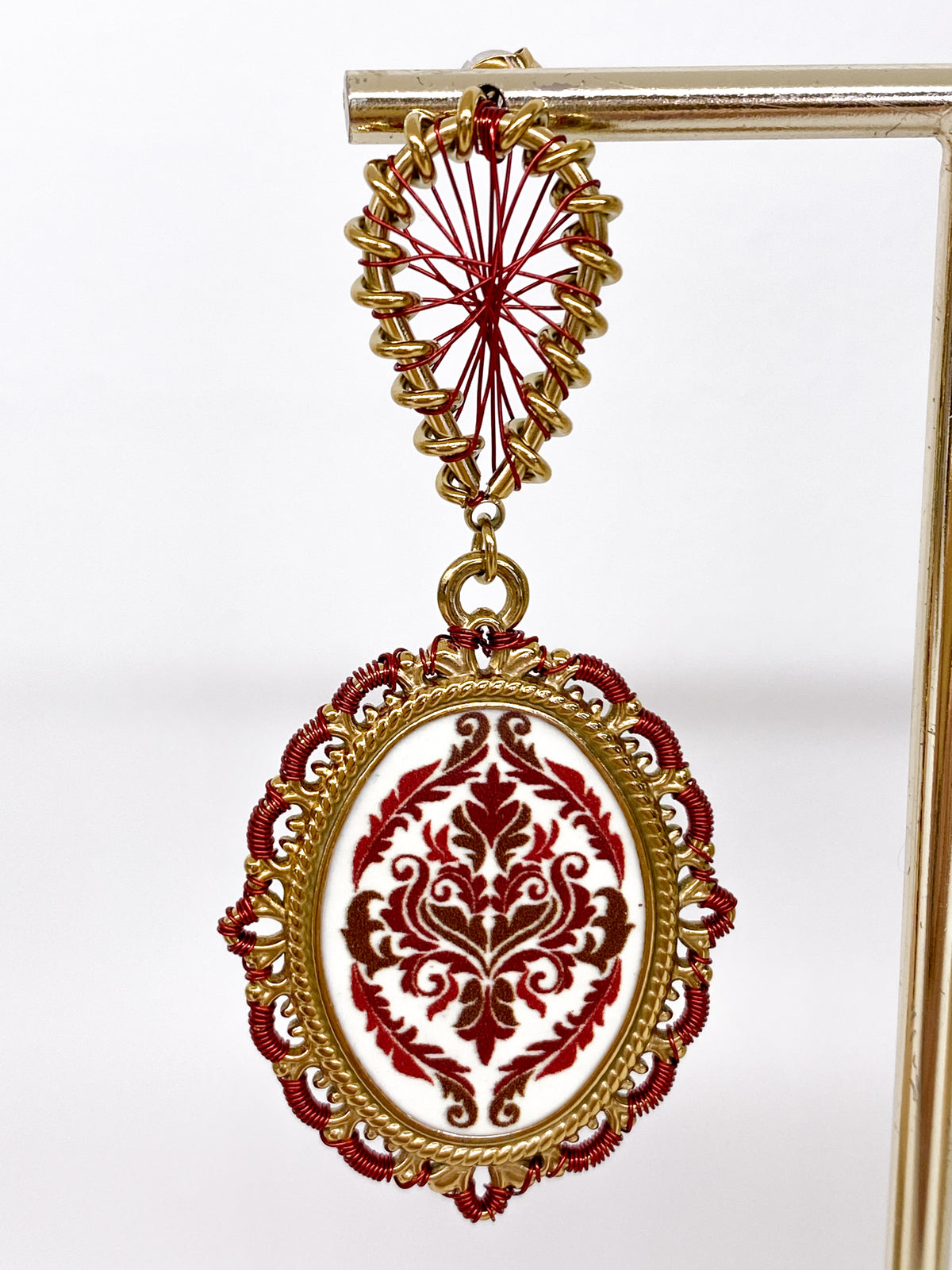 Boucles d’oreilles longues dorées avec motif damassé