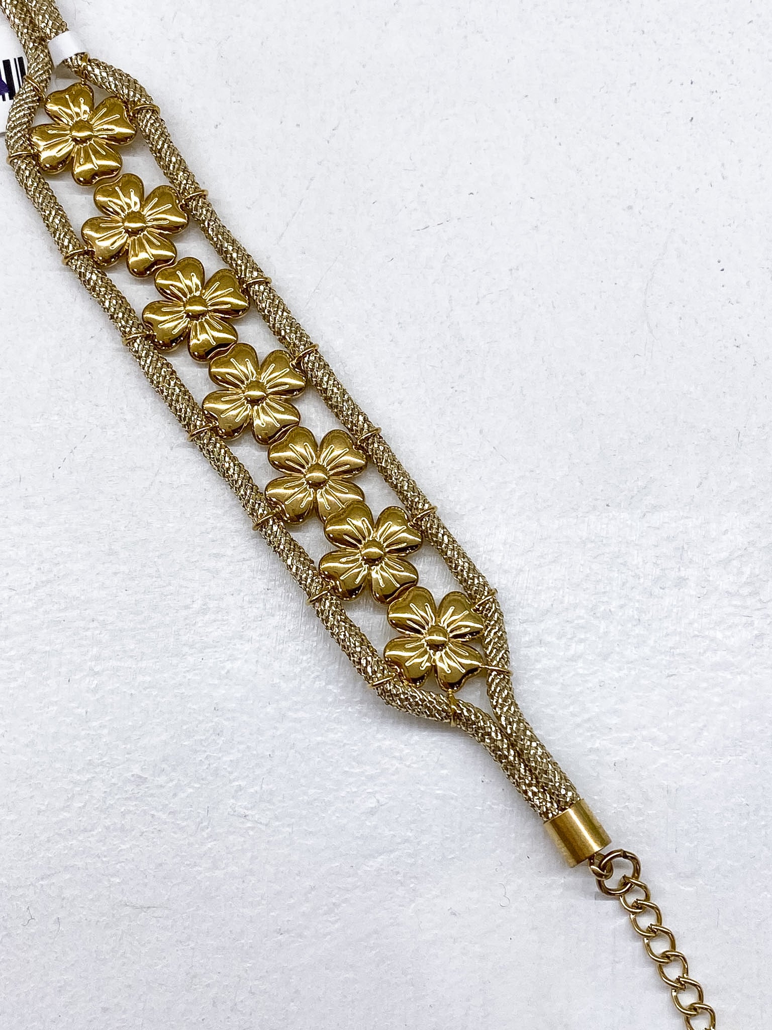 Bracelet large doré fleurs et cordons tressés